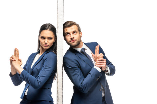 businessman and businesswoman separated by wall making gun gestures isolated on white