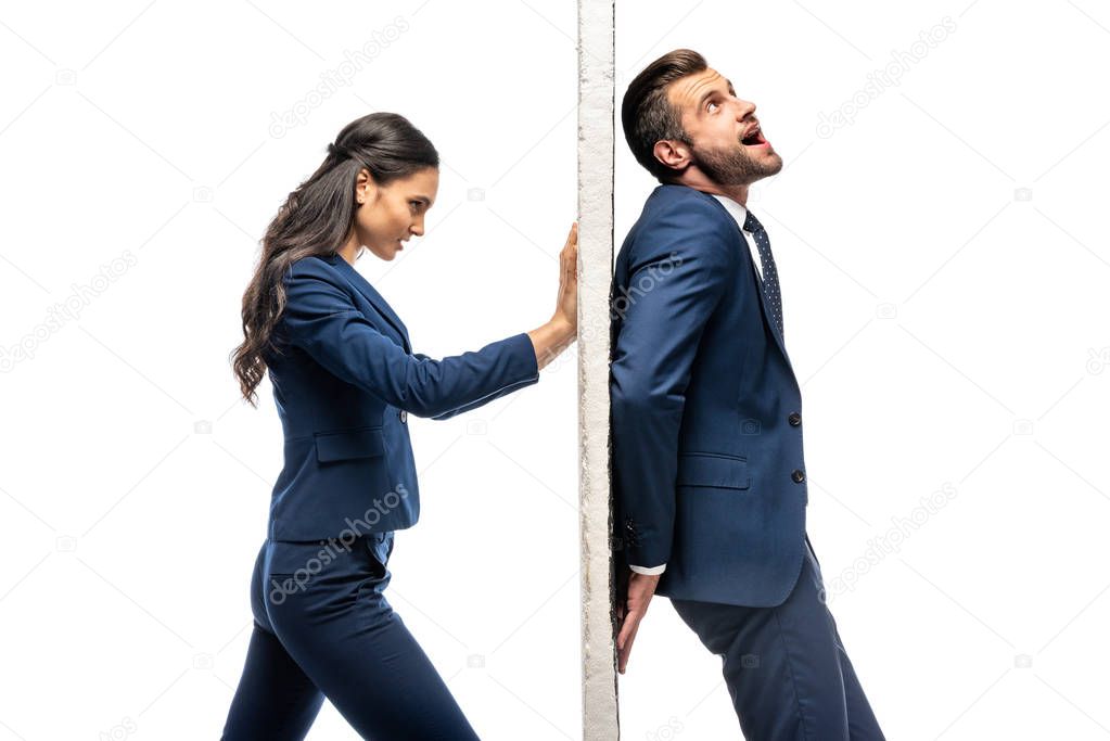 businessman and businesswoman in formal wear pushing wall isolated on white