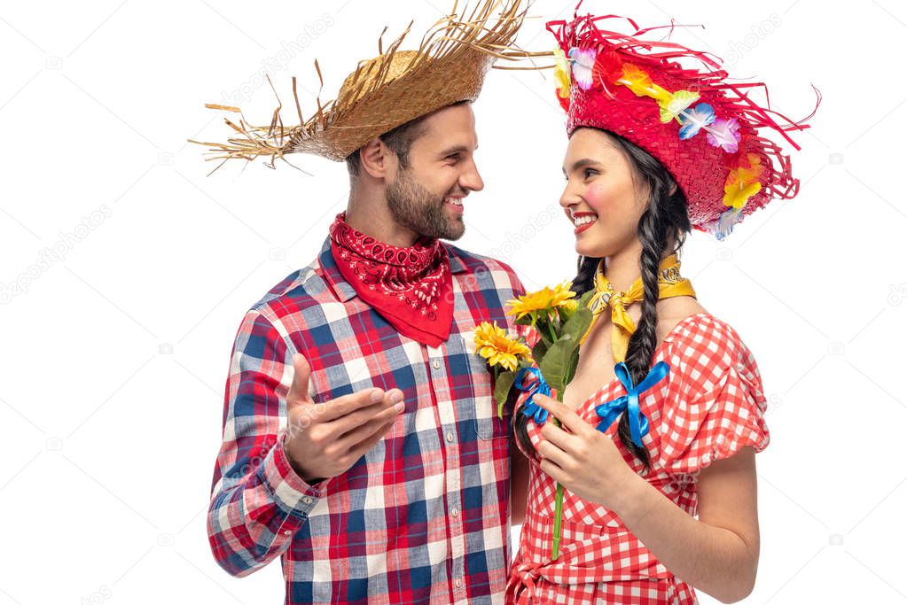 happy man and young woman in festive clothes with sunflowers isolated on white