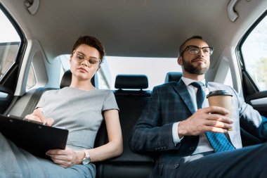 kağıt bardak ile iş kadını yakınında pano tutarken iş kadını yazma düşük açı görünümü 