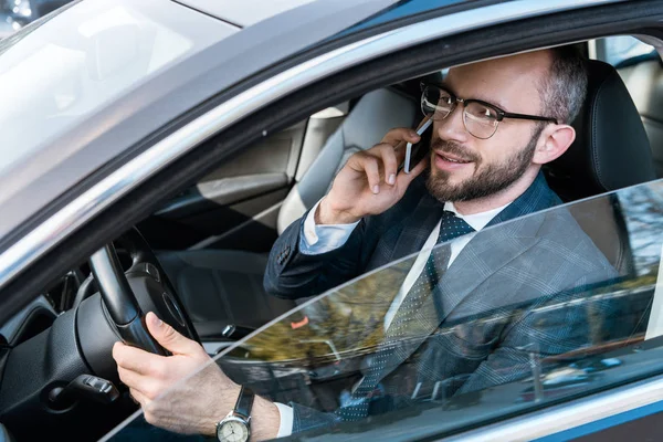 Όμορφος Επιχειρηματίας Γυαλιά Κρατώντας Τιμόνι Και Μιλώντας Στο Smartphone — Φωτογραφία Αρχείου