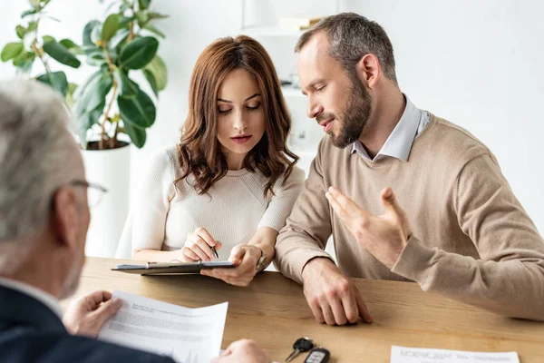 Selectieve Focus Van Man Gebaren Tijdens Het Kijken Naar Klembord — Stockfoto