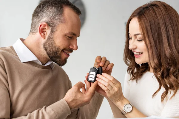 Cheerful Woman Looking Car Key Hands Handsome Bearded Man — Stock Photo, Image