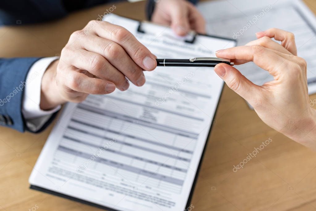 cropped view of car dealer giving pen to man near agreement 