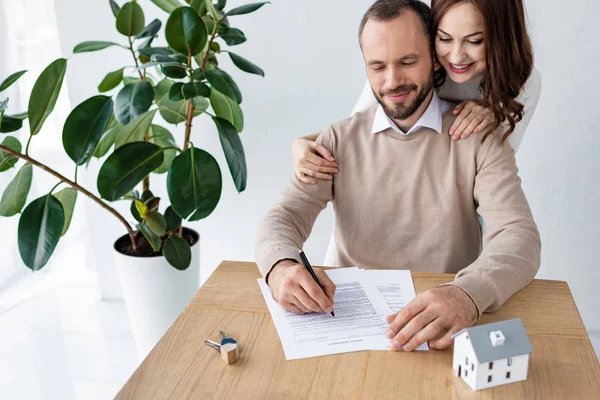 Hombre Guapo Firma Contrato Cerca Mujer Feliz Llaves Modelo Casa — Foto de Stock