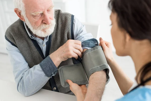 Selective Focus Nurse Measuring Blood Pressure Grey Haired Man — Stock Photo, Image