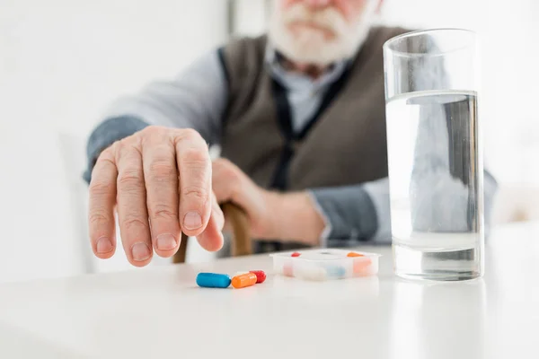 Beskuren Senior Man Plocka Upp Piller Från Bordet — Stockfoto