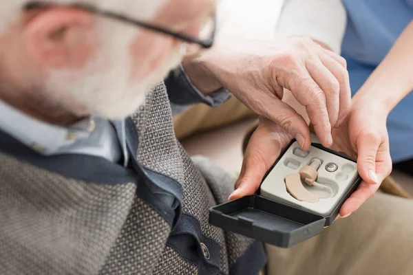 High Angle View Elderly Man Looking Box Hearing Aid — Stock Photo, Image