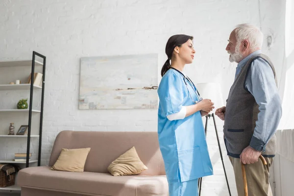 Hombre Pelo Gris Hablando Con Enfermera Pie Habitación Con Espacio — Foto de Stock