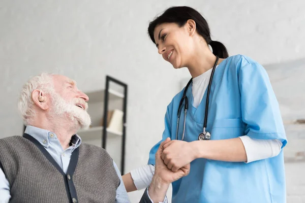 Low Angle View Smiling Doctor Holding Hand Senior Man — Stock Photo, Image