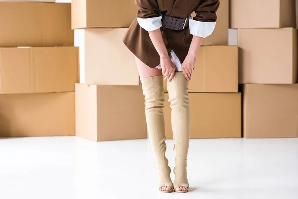 Cropped View Girl Touching Boots While Standing Boxes White — Stock Photo, Image