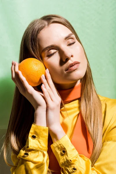 Attractive Blonde Woman Closed Eyes Holding Orange Green — Stock Photo, Image