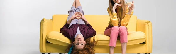 Panoramic Shot Redhead Girl Lying Sofa Blonde Woman Champagne Glass — Stock Photo, Image