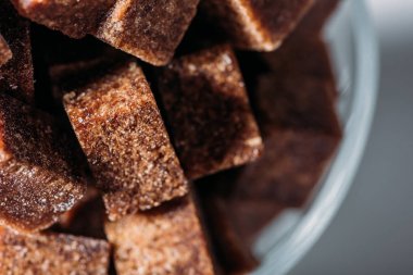 close up view of sweet unrefined brown sugar cubes  clipart