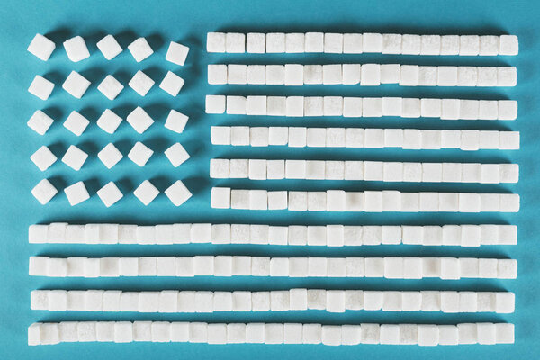 symbol of usa national flag made of white sugar cubes on blue surface