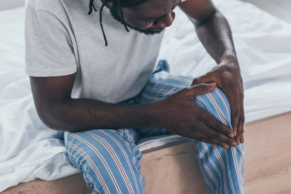 Cropped View Young African Man Suffering Knee Pain Bedroom — Stock Photo, Image