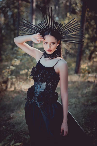 Elegant Woman Witch Costume Standing Forest Background Looking Camera Holding — Stock Photo, Image