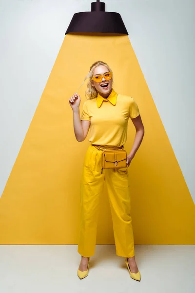 Happy Blonde Woman Sunglasses Touching Hair While Posing White Yellow — Stock Photo, Image