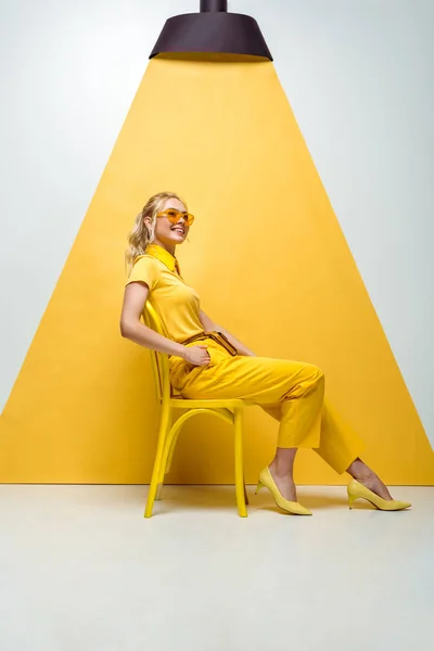 Happy Blonde Woman Sunglasses Sitting Chair White Yellow — Stock Photo, Image