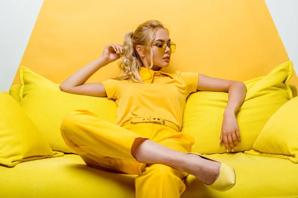 Attractive Blonde Woman Sitting Sofa Touching Hair White Yellow — Stock Photo, Image