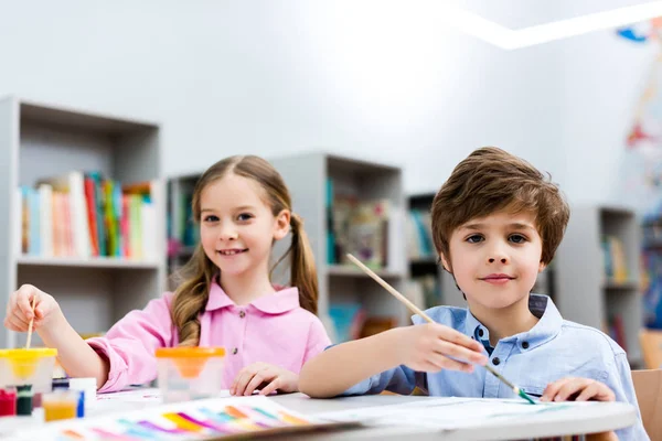 Selective Focus Cheerful Kids Looking Camera Holding Paintbrushes — Stock Photo, Image