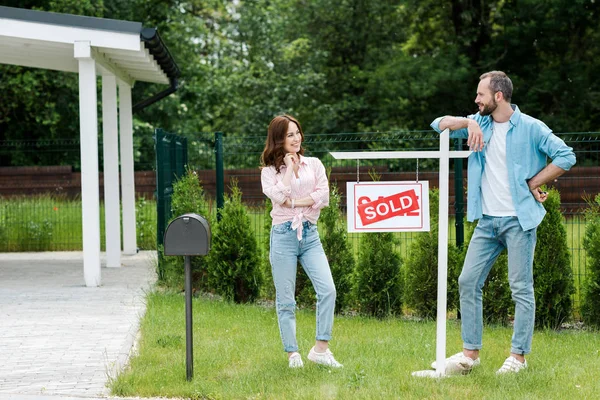 Cheerful Man Looking Attractive Woman Board Sold Letters — Stock Photo, Image