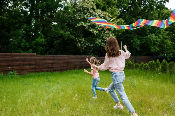 Back View Mother Running Cute Kid Colorful Kite — Stock Photo, Image