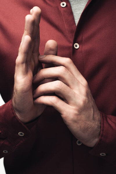 cropped shot of man gesturing with hands isolated on grey, human emotion and expression concept