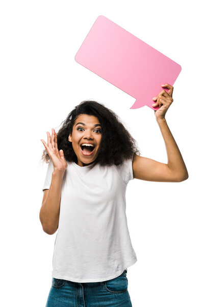 happy african american girl holding pink speech bubble and gesturing isolated on white 