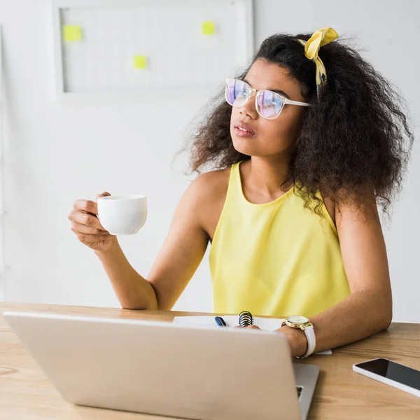 Thoughtful African American Girl Glasses Holding Cup Laptop — Stock Photo, Image