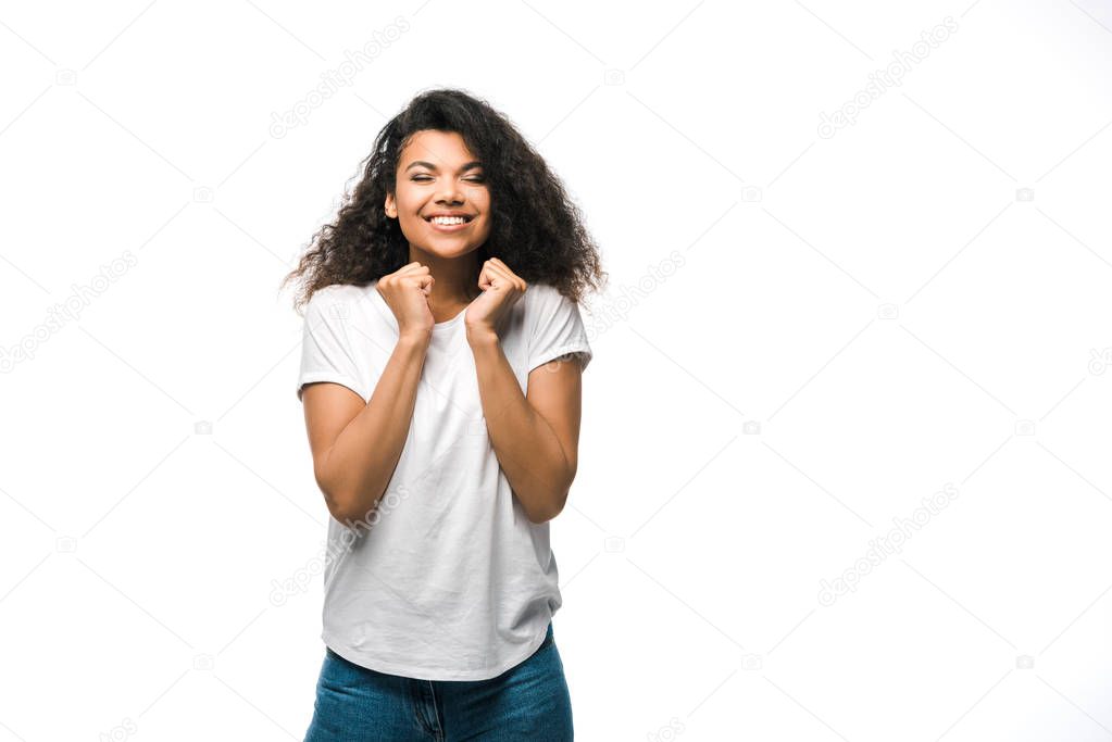 happy curly african american girl with closed eyes gesturing isolated on white 