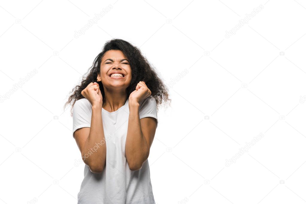 excited curly african american woman celebrating triumph isolated on white 