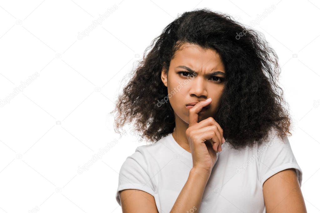 pensive african american woman touching face while looking at camera isolated on white 