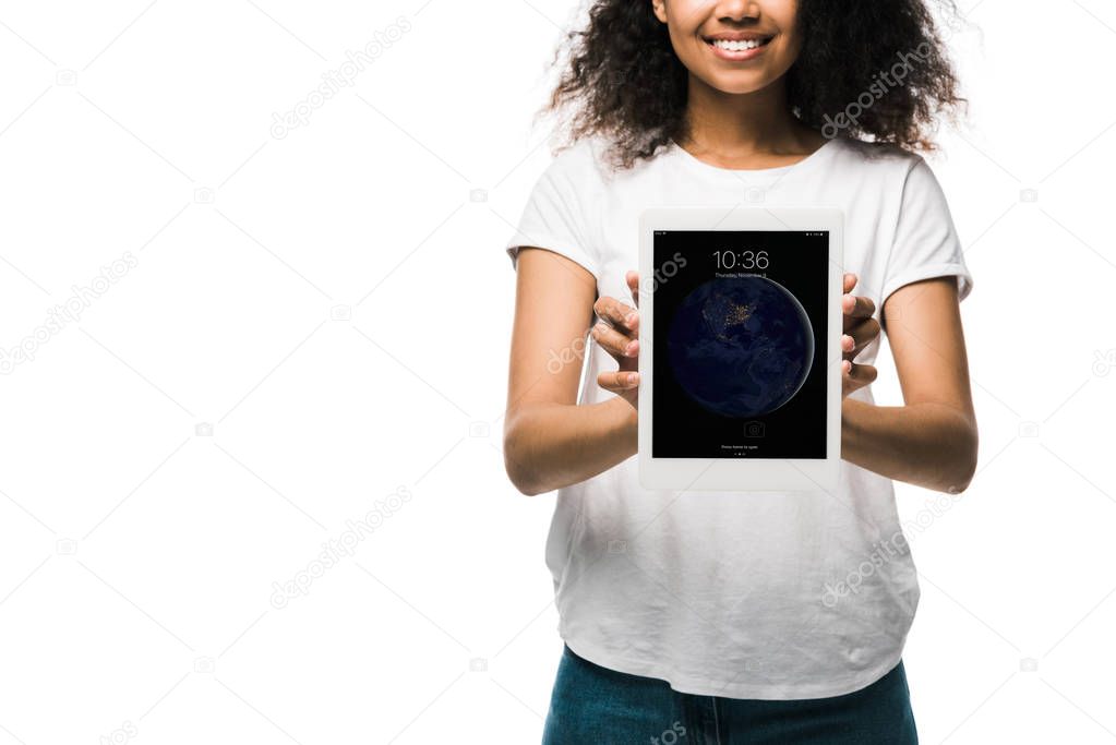 KYIV, UKRAINE - MAY 29, 2019: cropped view of happy african american girl holding ipad isolated on white 