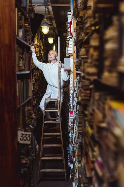 Blonde Prettty Woman Standing Ladder Holding Book Library — Stock Photo, Image