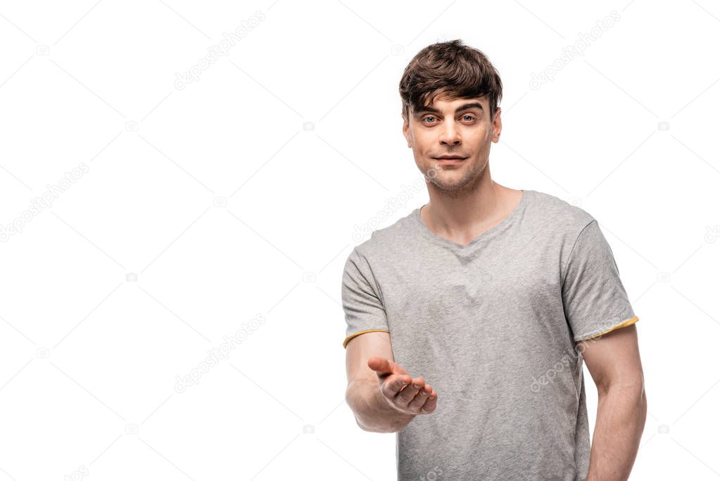 handsome young man with outstretched hand looking at camera isolated on white