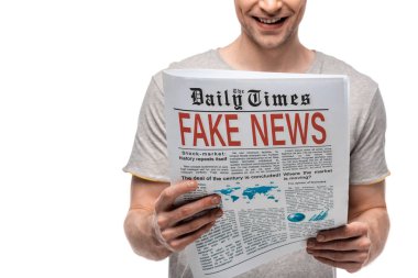 cropped view of young man reading newspaper with fake news isolated on white
