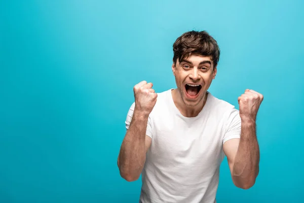 Happy Young Man Showing Winner Gesture While Looking Camera Blue — Stock Photo, Image