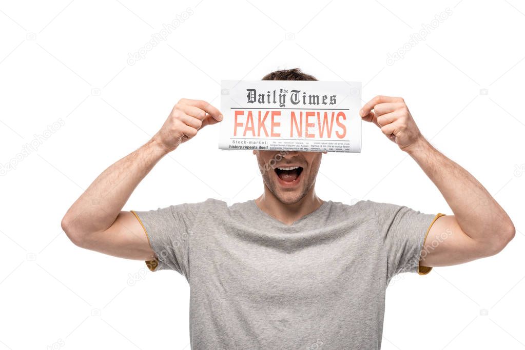 young man showing newspaper with fake news isolated on white
