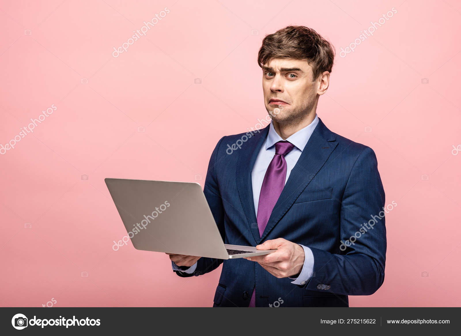 Disappointed Businessman Looking Camera While Holding Laptop Pink