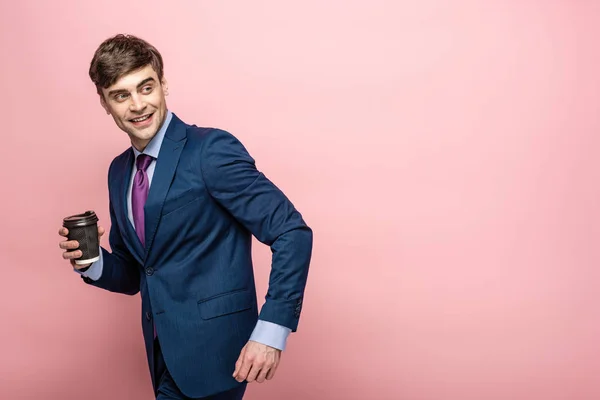 Cheerful Businessman Looking Back While Holding Paper Cup Pink Background — Stock Photo, Image