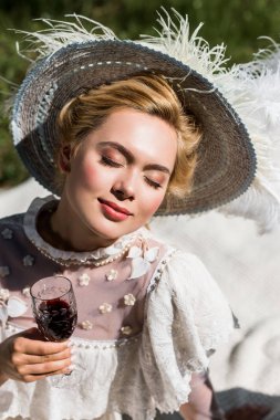 beautiful young victorian woman with closed eyes holding wine glass  clipart