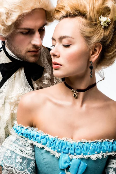 pompous victorian man looking at attractive woman in wig isolated on white