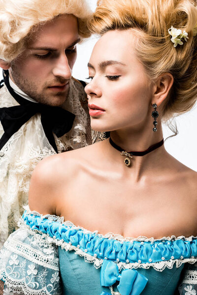 pompous victorian man looking at attractive woman in wig isolated on white  