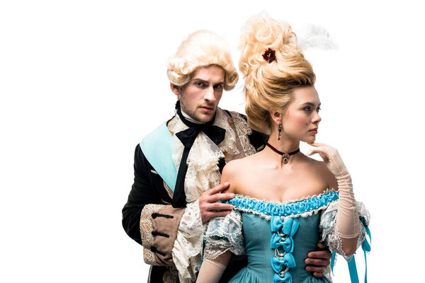 pompous victorian man looking at camera near attractive woman in wig isolated on white  