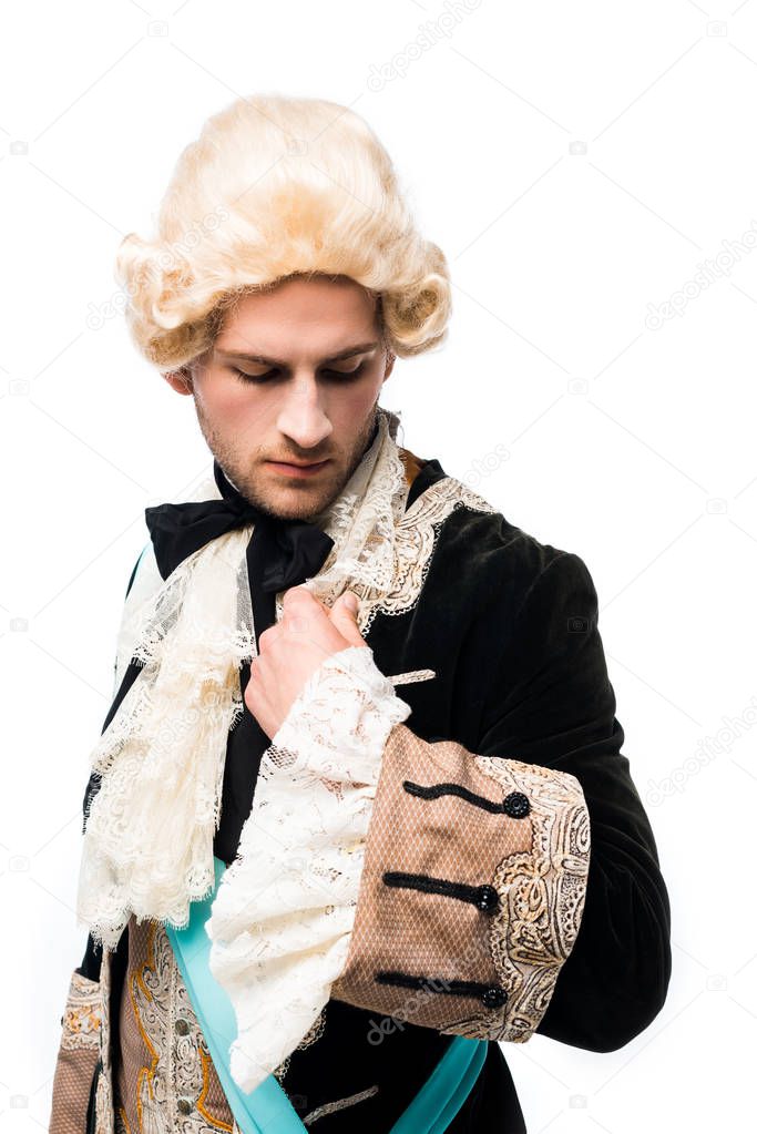 victorian gentleman in wig looking at suit isolated on white 