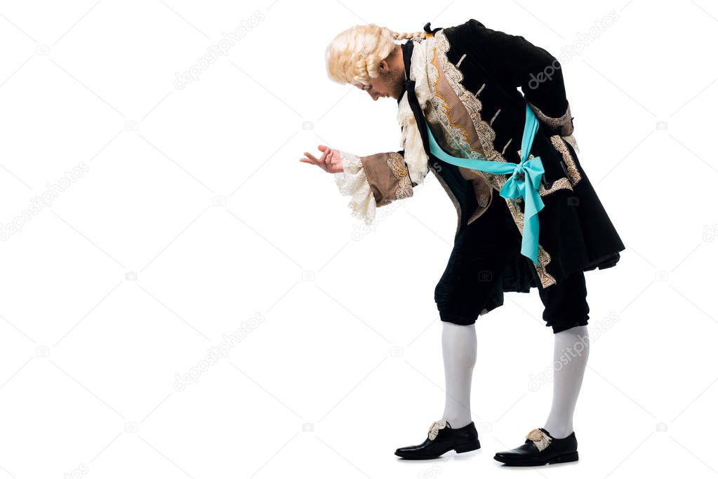 handsome victorian gentleman in wig gesturing while bowing down isolated on white 
