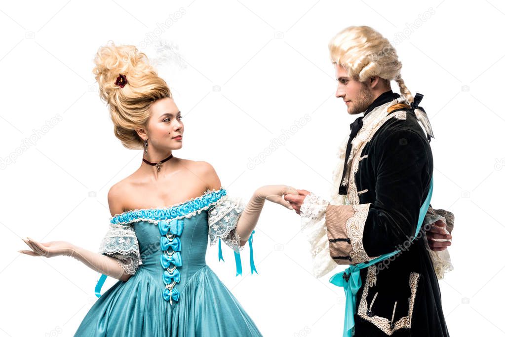 handsome gentleman holding hands with attractive victorian woman in blue dress isolated on white  