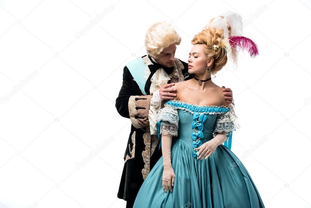 victorian man in wig touching shoulders of attractive woman in blue dress isolated on white 