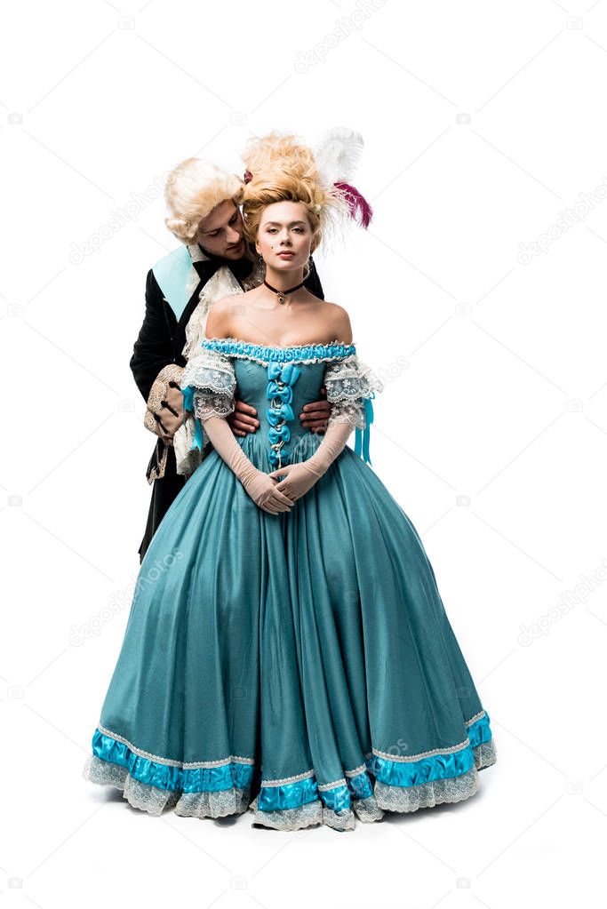 handsome gentleman looking at pompous victorian woman standing in blue dress isolated on white  